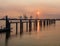 Pier in river Scheldt with container terminal at sunset, Port of Antwerp, Belgium