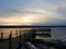 Pier silhouette reflection winter sunset on Cayuga Lake