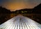 A pier, a small pier, a bridge on a frozen lake at night, long exposure