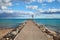 A pier of stones, a pier going into the sea. Dramatic sky with dark, heavy clouds