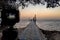 The pier and sunrise on the sea. Camera mounted on a tripod at foreground defocused