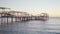 pier with umbrellas and sunbeds on the evening. beautiful sunset on sea.