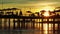 pier with umbrellas and sunbeds. silhouettes. beautiful sunset on sea.