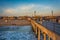 The pier and view of the beach at sunset, in Huntington Beach