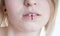 Pierced female lips with vertical labret piercing or lip ring