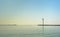 Piers of the harbor of ostend with modern radar tower, reflecting in the water of the sea