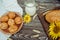 Pies or buns and a mug of homemade farm fresh milk, sunflower, baked goods and bread with flax seeds on a wooden background 1