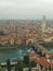 Pietra bridge and running water city view of Verona from hilltop in cloudy weather