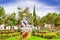 PIFO, ECUADOR - NOVEMBER, 13, 2017: Beautiful stoned sculpture of a woman waving with two sheeps in a park of Pifo