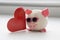 a pig with glasses. soft toy, red heart