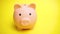 Pig money box at yellow background