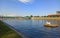 A Pig sculpture on the artificial cemetery island block on Vistula river in Krakow city against blue sky and bridge, Poland,