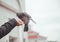 Pigeon feeding and balancing on woman`s hand. caring person feeds pigeons in the city in cold weather