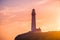 Pigeon Point Lighthouse historical building bathed in sunset light; Pacific Ocean coastline, Pescadero, California