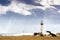 Pigeon Point Lighthouse on the Pacific Ocean coastline; sun rays bursting through storm clouds; Pescadero, San Francisco bay area