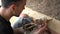 A pigeon takes food from a paper bag from a guy who wanted to feed him