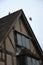 Pigeon taking flight from roof of traditional English Tudor house - timber framed Shakespeare`s birthplace, Stratford-upon-Avon