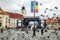 Pigeons fly in the big square of the European Union day