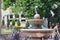 Pigeons fly over fountains in the square of the Central resort Park