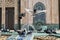 Pigeons playing with water in a mosque\'s fountain.