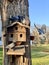 Pigeons are sitting on the roof in the dovecote. Bird feeder in the park. Wooden house for purebred pigeons