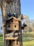 Pigeons are sitting on the roof in the dovecote. Bird feeder in the park. Wooden house for purebred pigeons