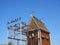 Pigeons are sitting on the roof in a dovecote. Wooden house for purebred pigeons. Birdhouse with a fence and a roof, aviary for