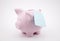 Piggy bank with blank reminder note