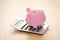 Piggy bank on calculator. Saving, accounting or banking concept.