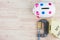 Piggy bank and coins squeezed tightly in a G-Clamp over wooden background