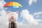 Piggy bank with colorful umbrella for saving money.