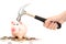 Piggy bank crashed or braked by hammer on money pile suggesting financial crisis