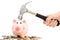 Piggy bank crashed or braked by hammer on money pile suggesting financial crisis