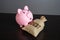 The piggy bank defeated debt. Write off part of the debt.