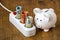 Piggy bank and electric extension cord with euro currency