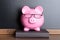 Piggy bank with eye glasses on book