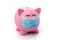 Piggy bank with facial sanitary mask and closed eyes