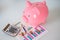 Piggy bank with finance sheet and money currency savings concept