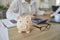 Piggy bank in form of pig on desk of female financier who works with calculator.
