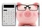 Piggy bank with glasses calculator and pen isolated on white