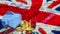 The piggy bank and gold coins on union jack flag Background 3d rendering