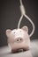 Piggy Bank with Hangman\'s Noose in Background