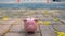 Piggy bank isolate in empty city foot-walk, saving money for spending in emergency or crisis pandemic