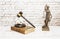 Piggy bank on judge`s gavel next to symbol of justice. Savings concept with security