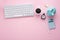 Piggy bank, keyboard, clock, calculator and coins on pink desk