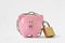 Piggy bank locked with chain and padlock on white background - Concept of savings and financial protection