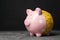 Piggy bank with measuring tape on table