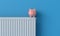 Piggy bank money saving box with a radiator. household heating cost concept. 3D Rendering