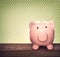 Piggy bank over green polka dots background