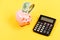 Piggy bank pig and calculator. Credit debt concept. Economics and profit management. Economics and finance. Investing